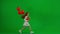 Children creative concept. A little girl in a white dress with red helium balloons on a green background comes into the