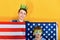 Children in a crown and a mask on the background of the American flag, the concept of world domination and government over others