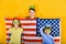 Children in a crown and a mask on the background of the American flag, the concept of world domination and government over others