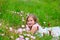 Children cute girl on spring meadow with poppy flowers