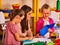 Children cutting paper in class. Development social lerning in school.