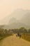 Children cycling, Sunset at limestone mountains of Vang Vieng, Laos