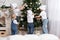 Children decorate a Christmas tree toys