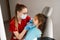 Children dentist examines child girl mouth and teeth and treats toothaches. Happy child patient of dentistry