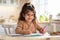 Children Development Activities. Cute Little Preschool Girl Drawing In Kitchen At Home