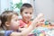 Children development - brother and sister making paper garland