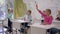 Children development, scholars raise geometric shapes in hands during lesson in classroom of Primary School