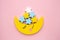 Children developmental toy for the development of motor skills, a crescent moon with stars balancer, on a pink background