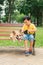 Children and dogs outdoors. Asian little boy enjoying and playing in park with his adorable Pembroke Welsh Corgi