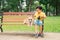 Children and dogs outdoors. Asian little boy enjoying and playing in park with his adorable Pembroke Welsh Corgi