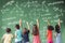 Children drawing math icon on the chalkboard