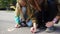 Children drawing with the piece of chalk