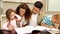 Children drawing at the table with their parents