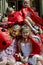 Children dressed as ladybugs sitting on retro car