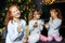 Children drink milk and eat cookies on Christmas Eve. Sisters in pajamas. The concept of Merry Christmas, holidays, family and