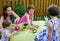 Children Dyeing Easter Eggs Outside