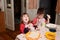 Children eating lunch at home, healthy food concept, kids enjoying bread and yogurt, sibling emotionally faces