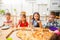 Children eating, table in scandinavian kitchen interiour.