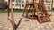 Children Empty swing in the yard of a high-rise building