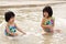 Children enjoy waves on beach