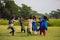 Children enjoying blind manâ€™s bluff game in the open field. Teenagers or young girls playing blind manâ€™s bluff game