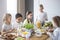 Children enjoying a healthy meal by a table in a dining room during a lunch break in a private primary school