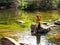 Children are enjoying playing in the water Green nature surrounded at Kaeng Hin Phoeng Rafting Prachin Buri Thailand