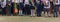 Children enrolled in the first class with bouquets of flowers in the hands on the school solemn line in the day of knowledge