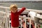 Children, experience ride on a ferry on a fjord, strong wind on the deck of a ferry on sunny day