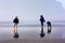 Children Explore Beach in Fog