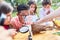 Children explore tree bark with a magnifying glass