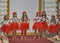 Children fashion models in red coifs and skirts
