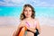 Children fashion surfer girl in tropical turquoise beach