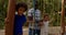 Children with father. Communication of families during a summer camp in forest.