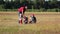 Children with the father spend time together in the field