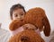 Children, fear and scary with a girl holding her teddy bear after a nightmare in her bedroom at home. Kids, anxiety and