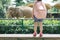 Children feed Asian elephants in tropical safari park during summer vacation. Kids watch animals