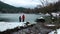 Children Feeding the Goose near the Lake in Winter