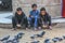 Children feeding pigeons