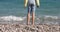Children feet standing on pebbles near sea shore 4k movie slow motion