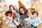 Children in festive attire and holiday hats make selfie, together at birthday party.