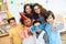 Children in festive attire and holiday hats make selfie, together at birthday party.