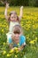 Children in field with flower.