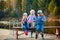 Children fishing with fishing rods. Warm autumn day. Fishing on a wooden pontoon