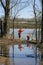 children fishing in a lake