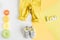 Children flat lay with clothes yellow background top view