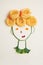 Children food concept, cute girl`s face made of ripe vegetables and Italian spaghetti pasta as hair, flat lay, top view