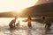 Children With Friends Enjoying Evening Swim In Countryside Lake