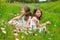 Children friends girls on spring poppy flowers meadow