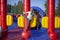 Children frolic on trampolines. Inflatable play area for children. Fun in the park. A child jumps on a soft construction installed